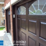 double fiberglass garage door with raised overhead panels and glass insert installed at Richmond hill home