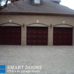triple Raised panel fiberglass Garage door with glass insert installed by smart doors in Markham