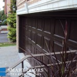Cedar overlay fiberglass panel garage doors installed in Toronto house