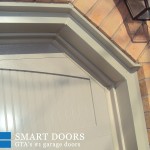 Overhead garage doors replacement in Toronto features pair of two raised panel doors installed with capping