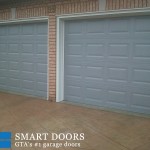 Overhead garage doors replacement in Toronto features pair of two raised panel doors installed