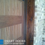 Wooden accent garage doors installed by smart doors in Markham home
