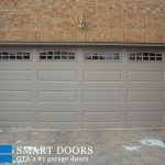 Markham garage door replacement project showcasing raised panel garage door with glass inserts installed by smart doors