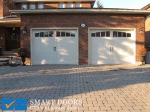 Set of Two new white carriage style steel panel garage doors by Smart Doors
