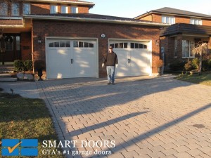 Toronto home got new overlay panels carriage style garage doors