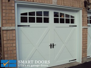 Carriage style white fiberglass overlay garage doors installed in Toronto