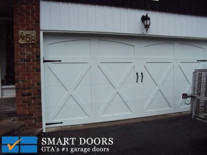 White Steel panel barn style garage doors installed in North York