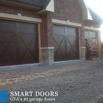 Toronto Garage door replacement project featuring barn style garage doors with window insert installed