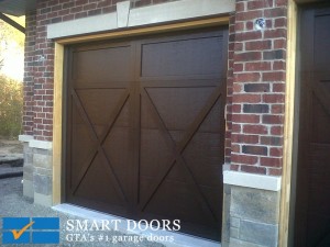 Toronto Home got new barn style steel garage doors with wood overlay