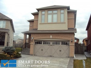 Double panel carriage style insulated doors with window and black hardware