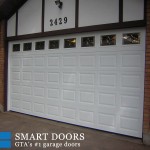 white aluminum garage door replacement in Toronto featuring raised panel fiberglass door