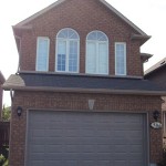 sandstone raised panel overhead garage door with window installed in North York