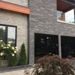 Custom made black glass garage doors installed in Markham