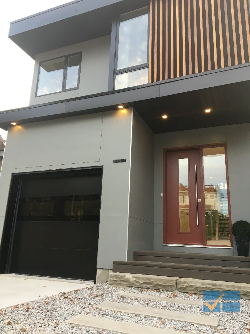 Modern Flush Black Panel Garage door installed in Maple