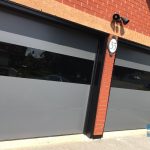 Modern Smooth Garage door with glossy glass insert and Matt finish installed in Bolton