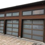 Triple bay glass panel overhead garage doors installation in Toronto