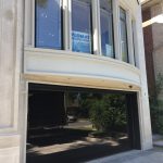 Smart Doors Toronto Installation featuring smooth black glass garage door with glossy black finish