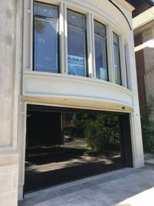 Smooth black glass garage door in gloss