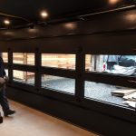 Smooth finish Modern Black Glass Garage Doors installed in Toronto home