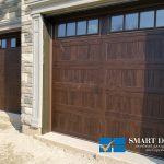 Overhead Garage Doors installation in Toronto featuring triple classic carriage style doors in wood finish texture
