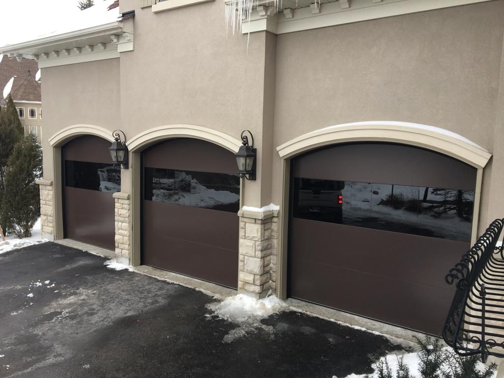 Arched modern garage door Toronto installation in Keele by Smart Doors