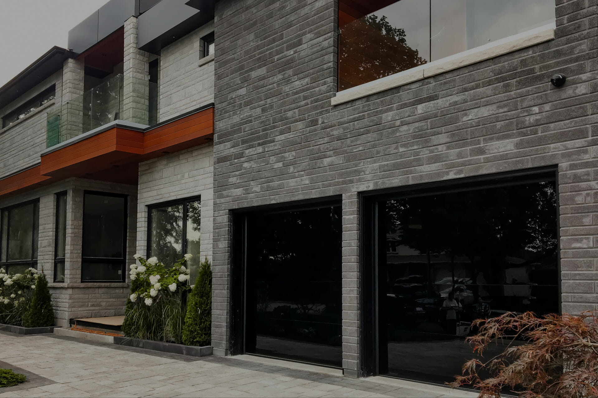 Black smooth glass overhead garage doors by Smart doors