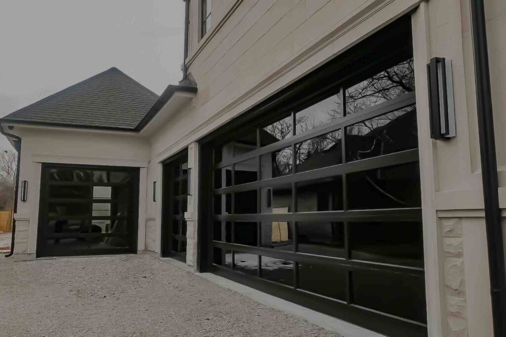 aluminum and glass garage doors being installed by smart doors